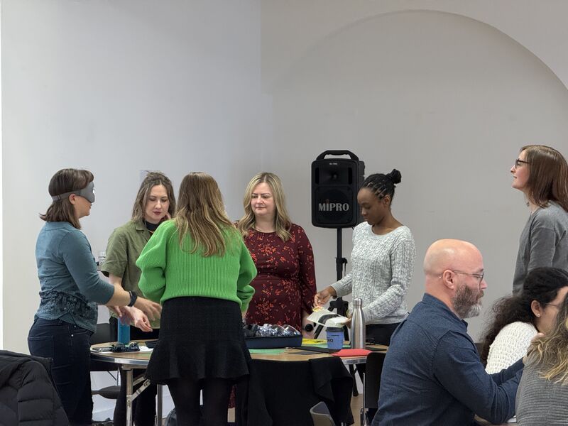 A group of participants and one of the experience's vision stations.