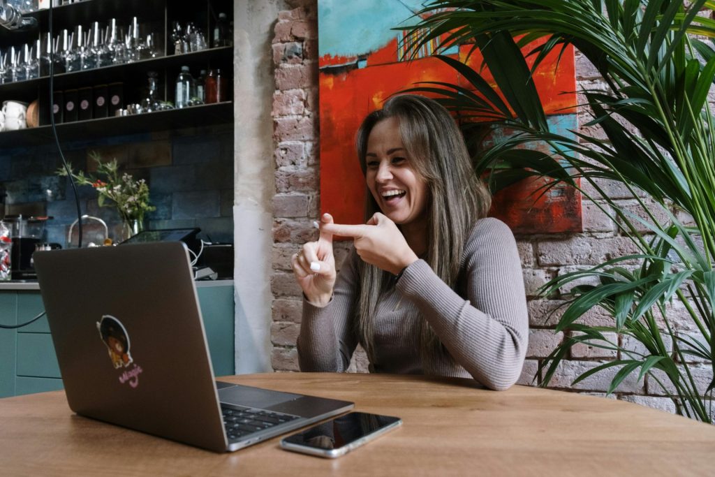 Lady working on laptop while happy